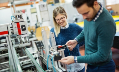 Students work on machine