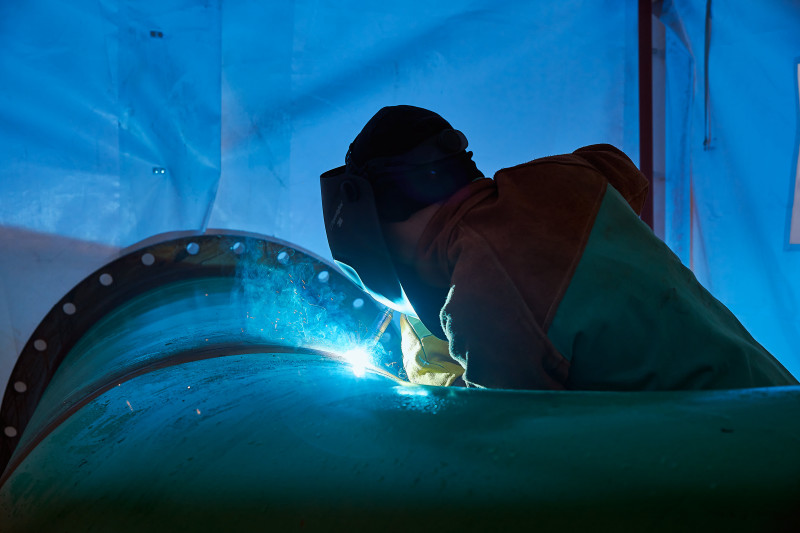 2 employees working on pipes