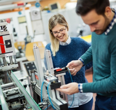 Students examining a machine